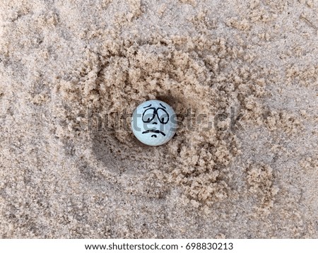 Golf ball in sand bunker at golf course