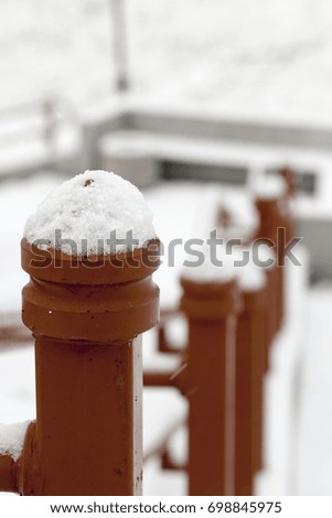 photographed close-up metal railing near the steps. Winter time of the year, the structure is covered with snow