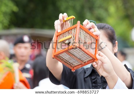 Release of caged birds is a way to cultivate the Buddhist way of life in Southeast Asia. Believe that will make suffering without disease. Make merit of Buddhist charity. In life donation. Royalty-Free Stock Photo #698853727
