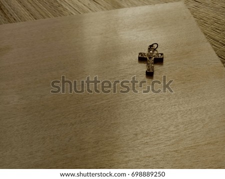 Old Christian Cross accessories on wooden background, morning sunlight