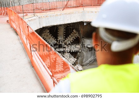Workers inspecting construction works on a scaffold inside construction site