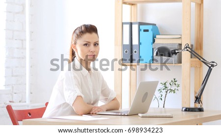 Designer Woman at Work Looking toward Camera