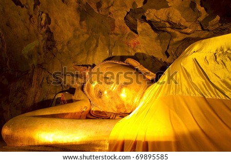 Reclining Buddha in a cave Khao Luang, Petchaburi Province, Thailand.