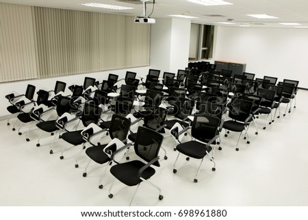 Rows of empty chairs prepared for meeting in the conference room