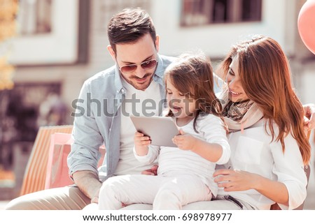Happy family.Young beautiful mother,father and daughter having fun,taking selfie.