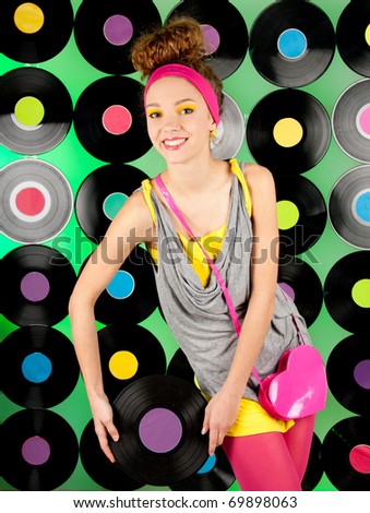 studio shot of cheerful teenage girl over the colorful background