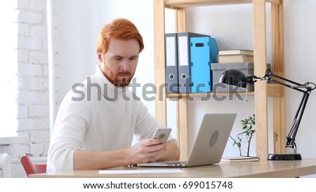 Using Smartphone, Browsing Man with Red Hairs
