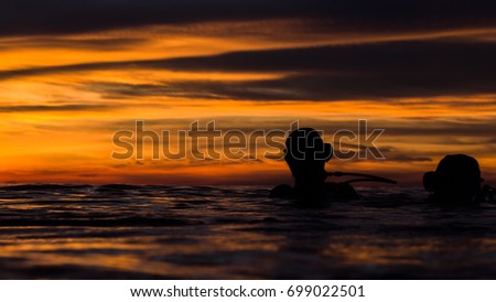 beautiful sky in golden hour when diver floating on the water before start dive