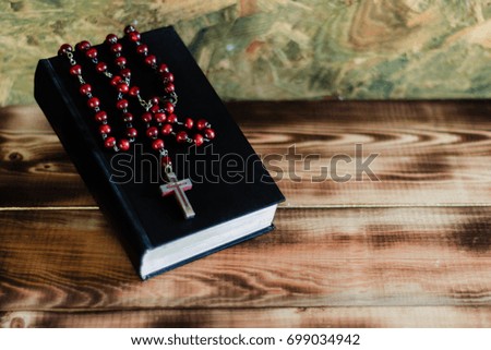 Bible and the crucifix on a wooden dark table. Beautiful background.Religion concept.