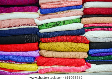 Multicolored fabric stacks, fabric background in the market