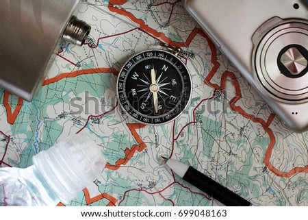 Compass and a camera on the map, a set of traveler
