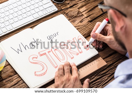 Elevated View Of Businessman Asking What's Your Story On Notebook Over The Office Desk