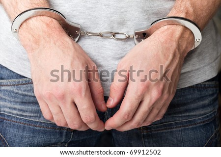 Police law steel handcuffs arrest crime human hand Royalty-Free Stock Photo #69912502