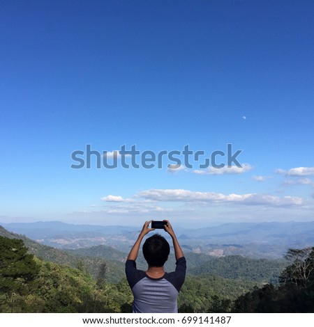 Man taking photo on beautiful landscape