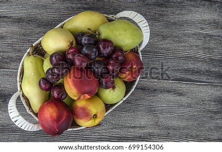 Mixed apple, pear, nectarine and plum pictures in a fruit basket