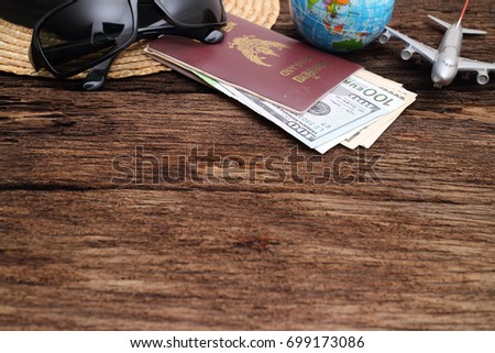 travel concept , Go on an adventure, The world map and the passport and money on a wooden table. Top view. 