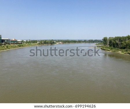 Photo looking north over the Missouri river from the bridge on a warm summer day 