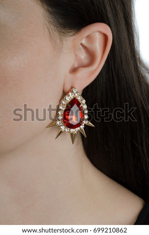 woman wearing fashion earrings on white isolated background