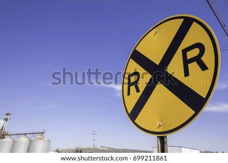 Railroad crossing sign shown on a post