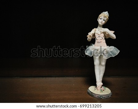 Ballet Girl Doll Ceramic Stucco on Wood Background Royalty-Free Stock Photo #699213205