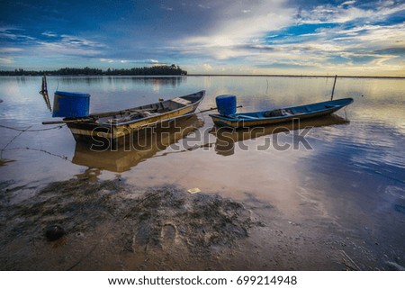 Amazing sunset (sunrise) in Malaysia. Boats in the bay on the coast. Relax on the beach. Sunrise bay with boats. Beautiful landscape.