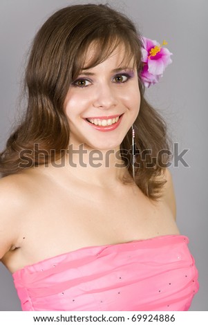 Portrait of the beautiful girl with a flower in hair
