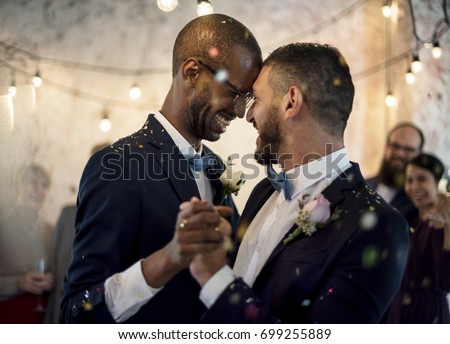 Closeup of Newlywed Gay Couple Dancing on Wedding Celebration Royalty-Free Stock Photo #699255889