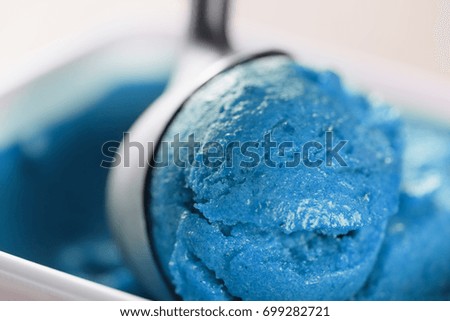 scooping blue ice cream close up