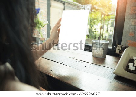hand hold blank square paper over blur background