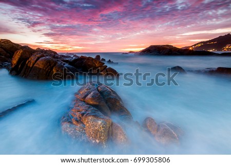 Seascape landscape nature in twilight and rock with colorful of sunset over the sun, Beach Sea, Sunset Sunlight or Sunrise, Twilight Sky Scenic with Sun Silhouette.Image is soft focus.