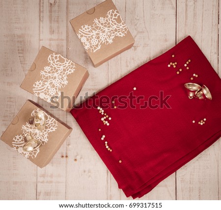 Christmas decorations, gift boxes and food on vintage style table top.