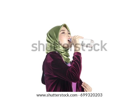 Portrait of a active healthy hijab woman drinking plain water in bottle for promoting a healthy fitness and lifestyle concept.isolated white background