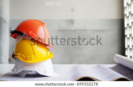 Hard safety helmet hat for safety project of workman as engineer or worker on concrete floor. Royalty-Free Stock Photo #699332278