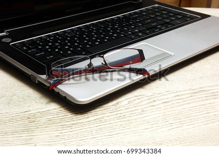 Glasses and laptop. Close-up