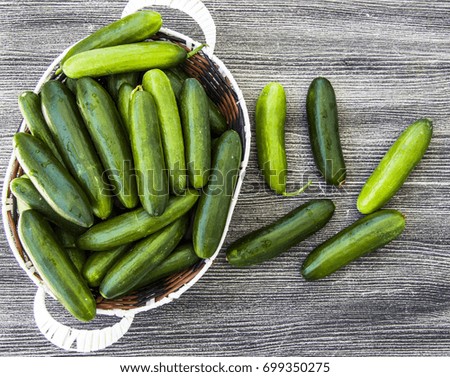 Pictures of natural healthy cucumbers in a basket