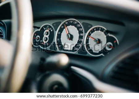 Driving car background. Speedometer speed limit indicator symbol. Dark elegant luxury car steering wheel. Vehicle drive transportation backdrop.