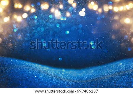 glitter vintage lights background. blue, gold and black. de focused