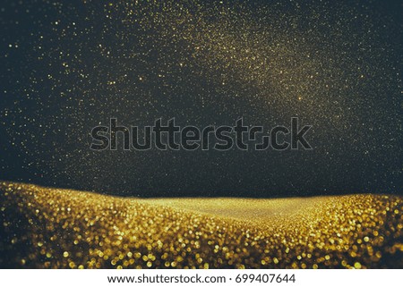 glitter vintage lights background. gold and black. de focused.