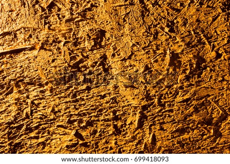 Clay wall in golden light as background