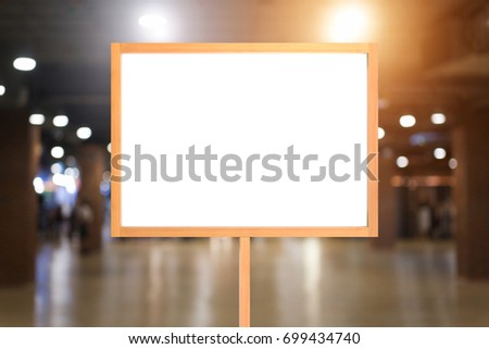 White poster with wood frame mockup on blurred background. mock up.