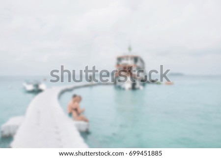 Blurred of People sitting on the walkway to yacht boat.There is clear space in foreground to adding object .