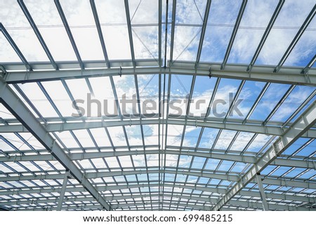 Steel structure roof truss under the construction building in the factory with blue sky