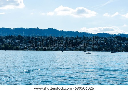 lake water view with urban city area and mountain and blue sky