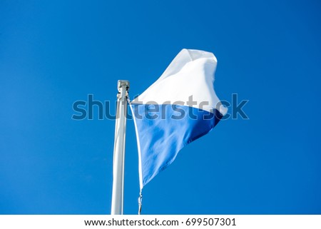 flag of zurich switzerland with blue sky