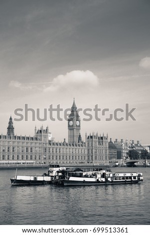 Big Ben and House of Parliament in London with boat in Thames River.