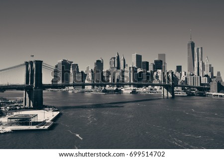 Manhattan financial district with skyscrapers and Brooklyn Bridge.