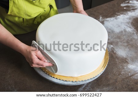 Unrecognisable woman in bakery decorating wedding cake with white fondant. DIY,  sequence, step by step, multiple image.