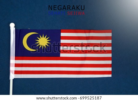 Malaysian flags with words " NEGARAKU SEHATI SEJIWA" which means my nations, one heart in english. Royalty-Free Stock Photo #699525187