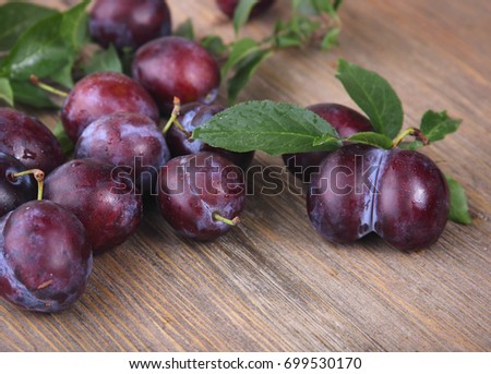fresh plums on wooden table