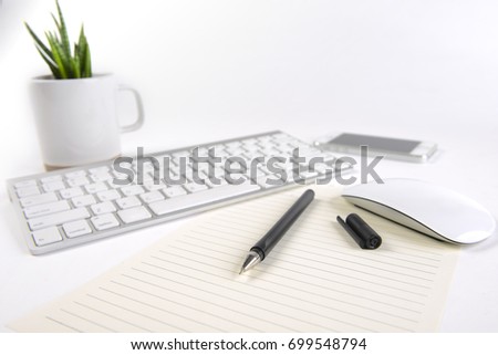 Office table with keyboard, mouse, notebook and smartphone on white background.